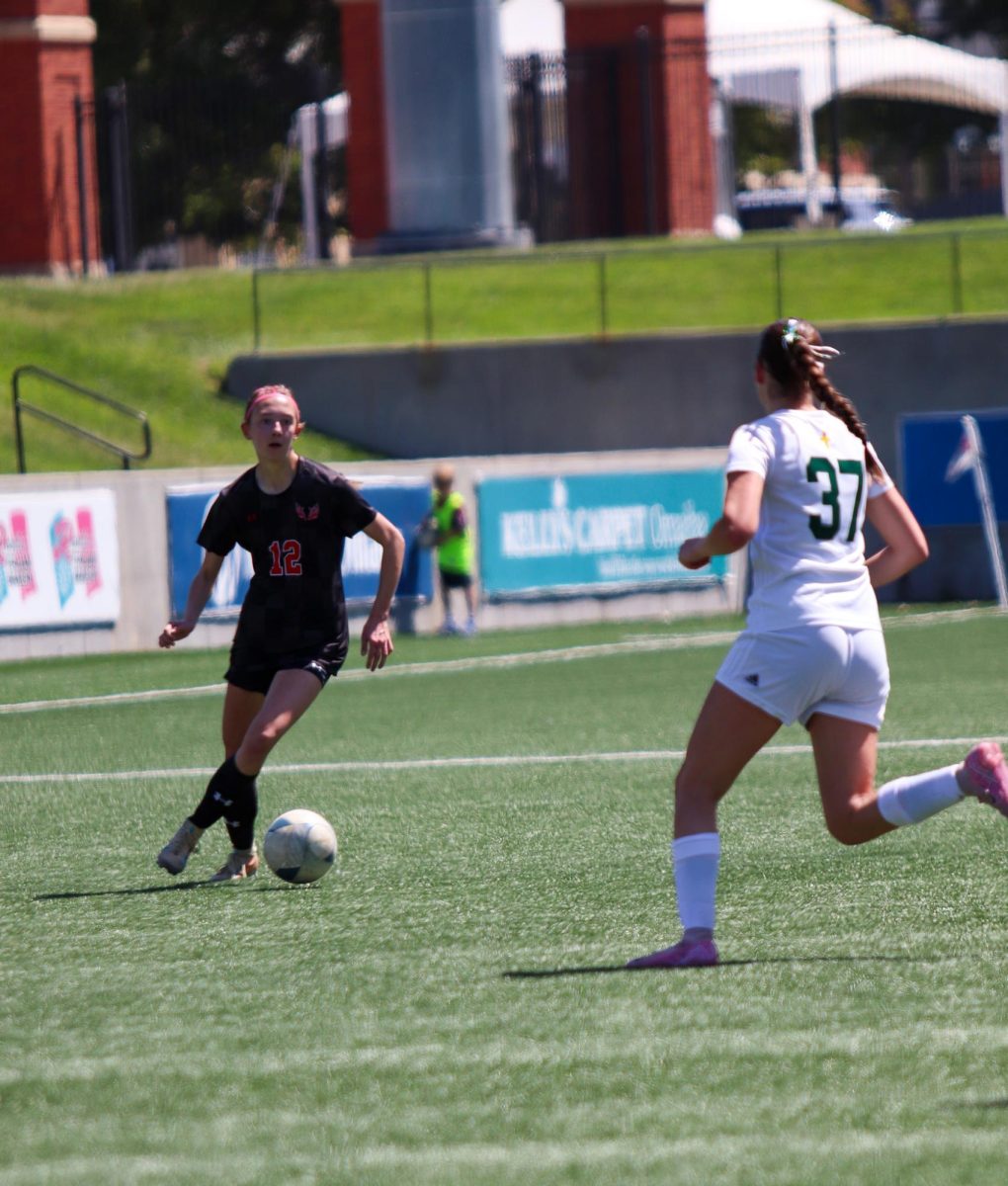 Freshman Neeley Harnisch dribbles past a defender in the first round of the state tournament.
