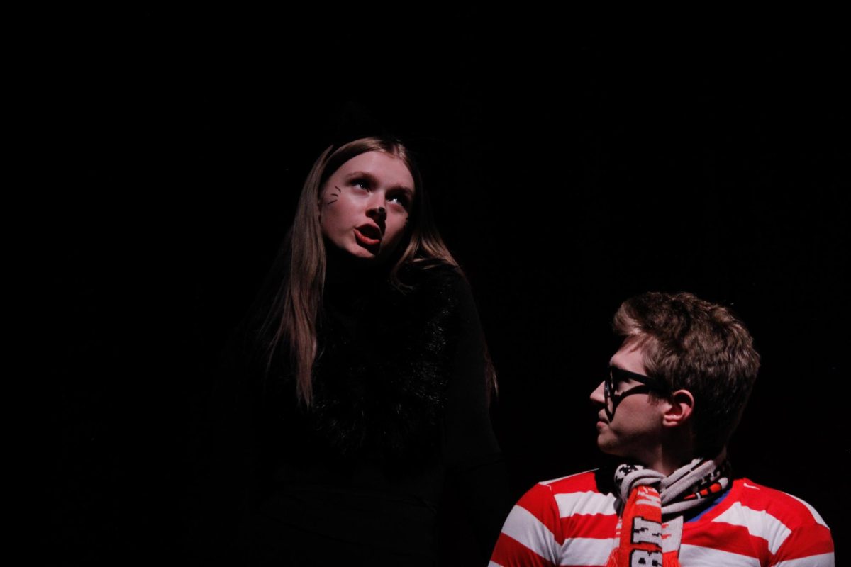 Panther Lady, played by sophmore Rylee Loontjer is having a serious conversation with Waldo Puppybreath, played by senior Taylor Kohn.